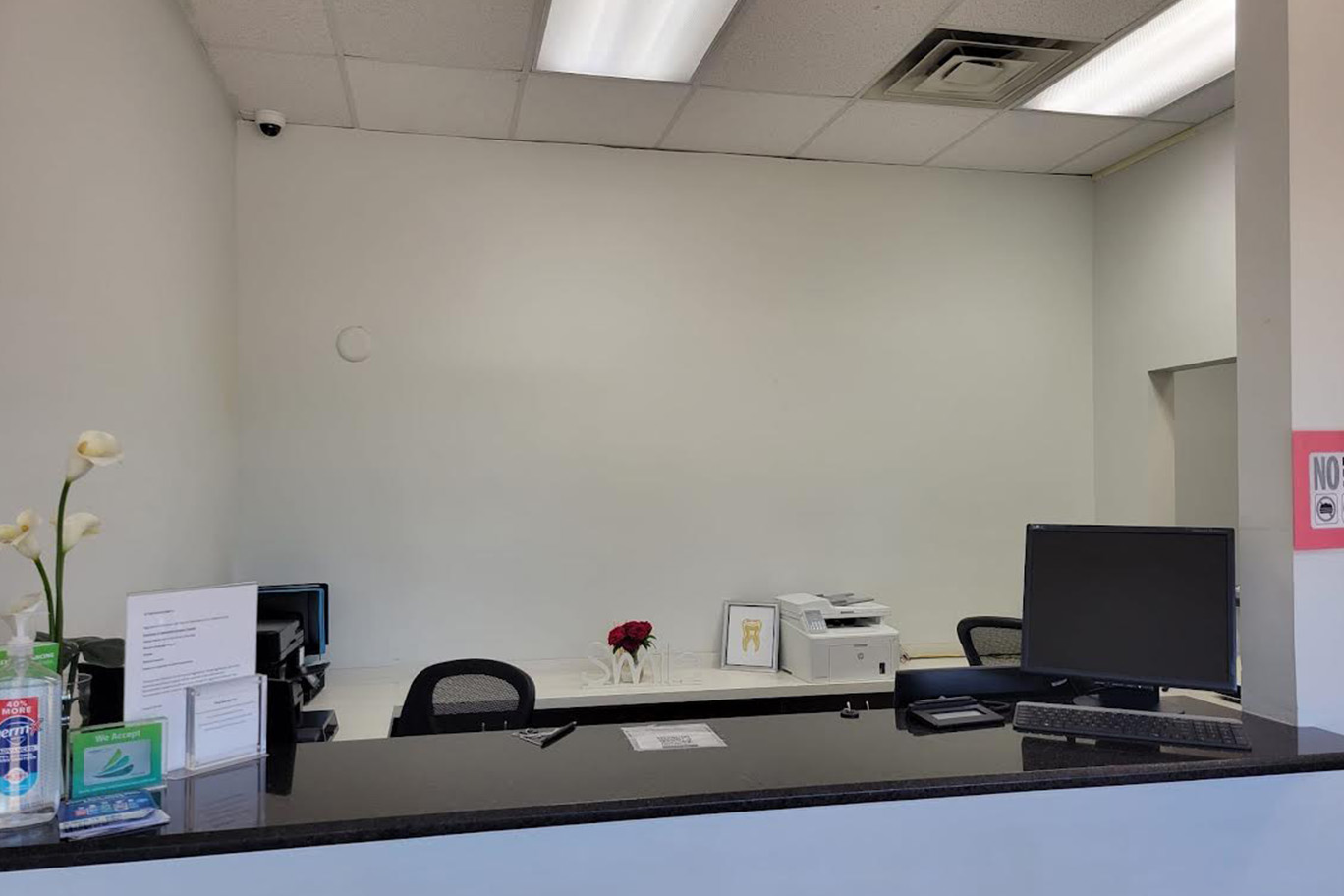 The image shows an interior view of a room with a counter, a chair, and a computer monitor.