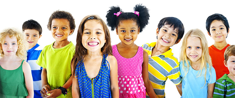 A diverse group of children and adults posing for a photo with bright smiles.