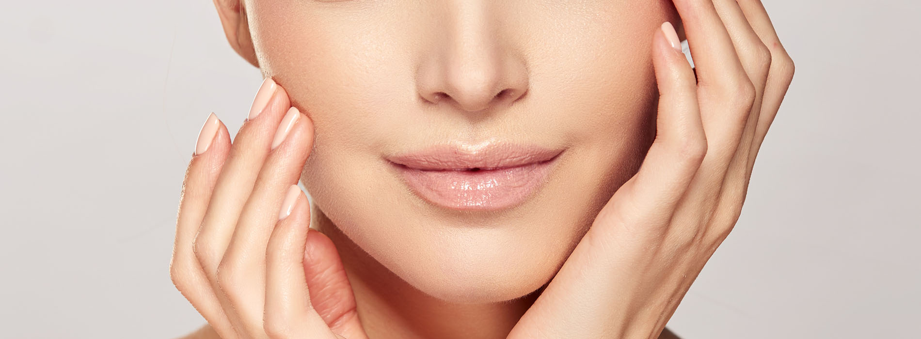 The image is a close-up photograph of a woman s face, focusing on her eyes and the application of makeup or skincare products.